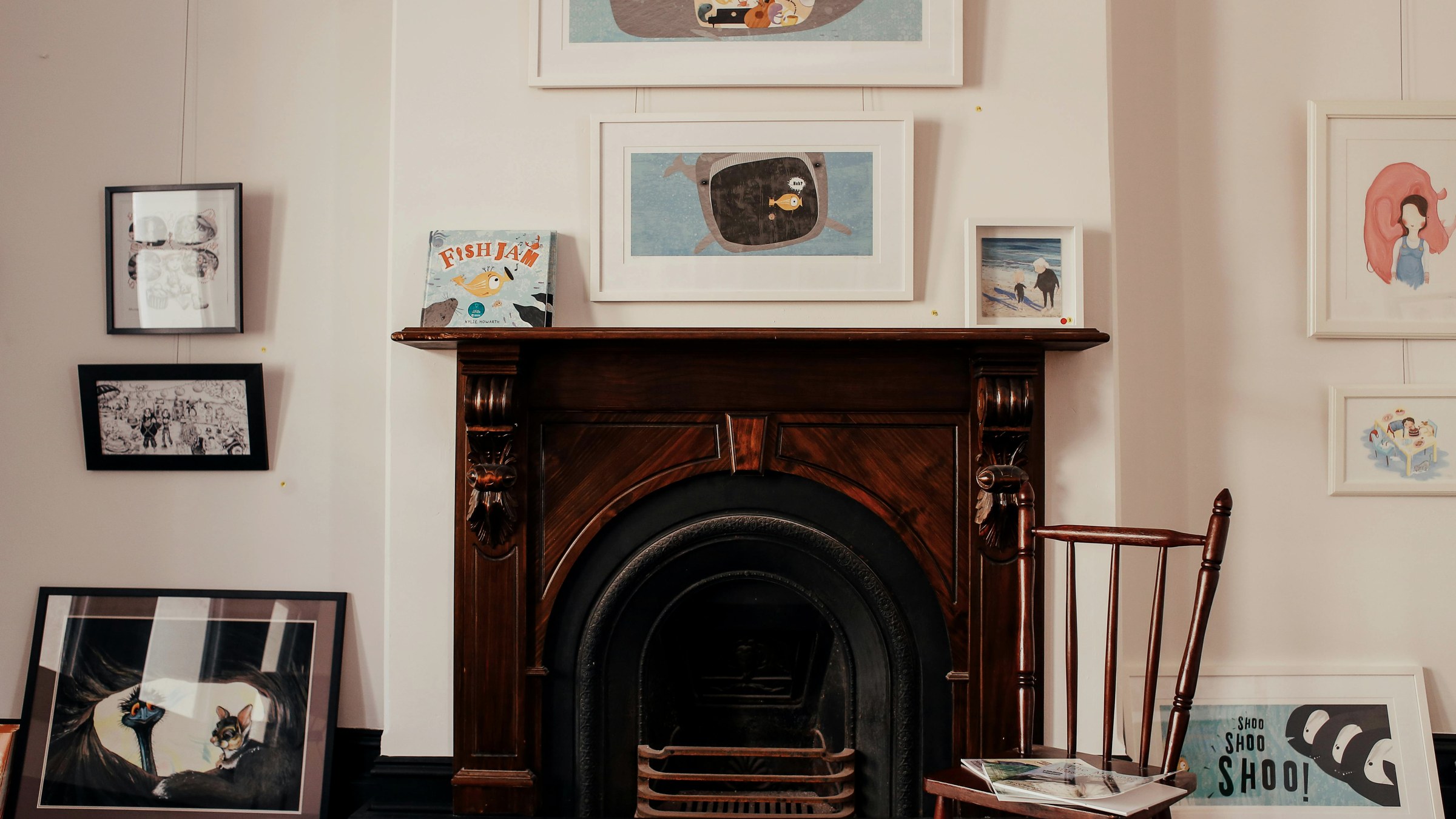 Warm living room with framed artwork on the walls — art displayed in a stay-worthy home setting.